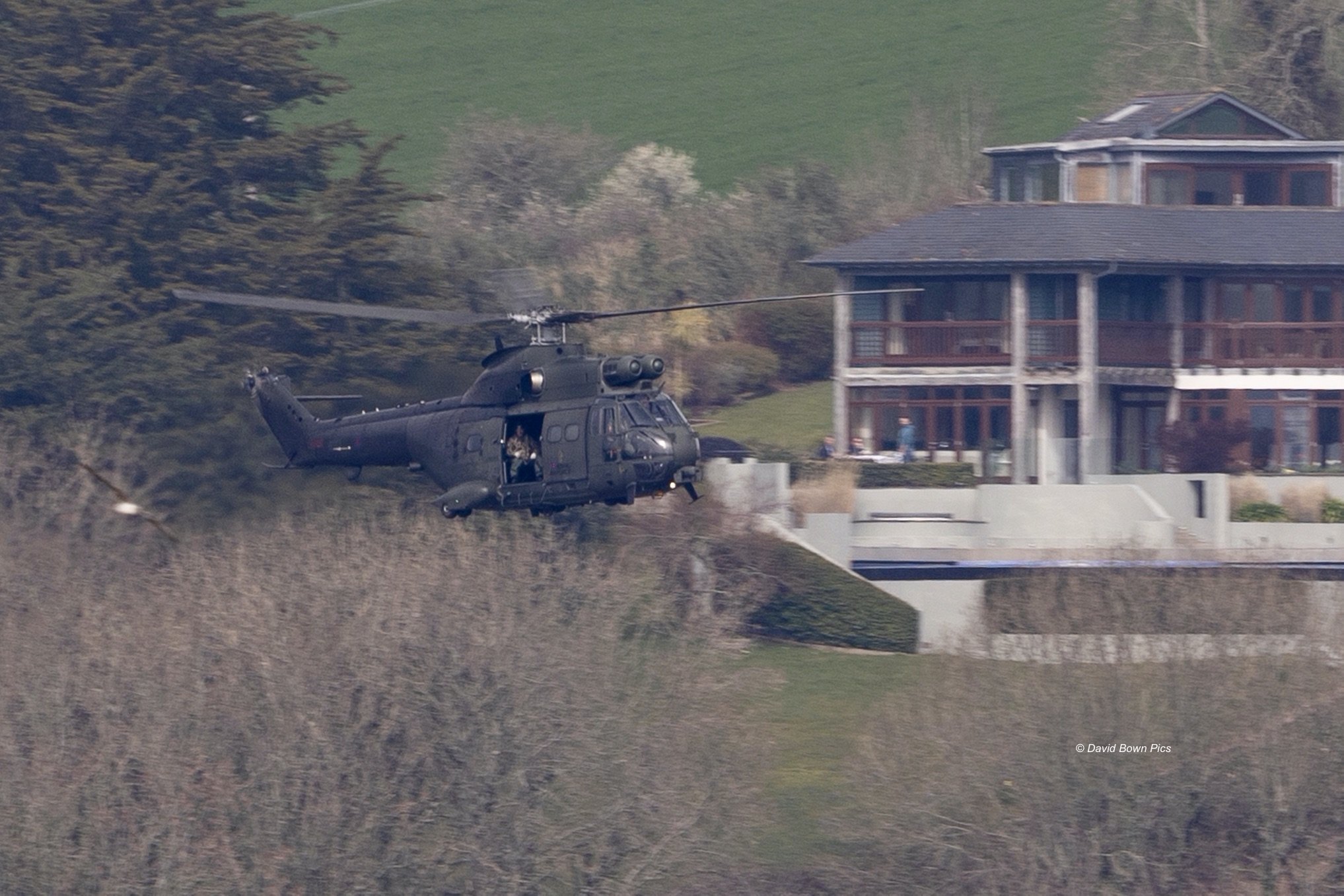 RAF PUMA XW204 passing a house in Kingswear